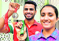 Arpinder Singh and Navjeet Kaur Dhillon showing their medals at NIS in Patiala on Thursday