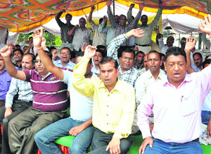 Employees of the Revenue Department protest at the Parade Ground in Dehradun on Thursday.