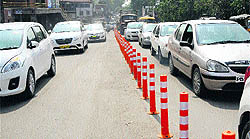 Traffic flows through dedicated lanes, created by installing fixed cones on a busy portion of Bhandari Bridge in Amritsar on Friday