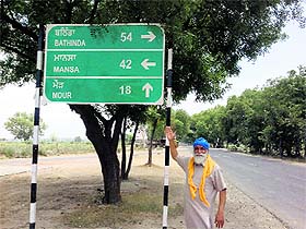 A man shows wrong signages in Rampura Phul.
