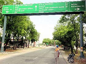 A man shows wrong signages in Rampura Phul.