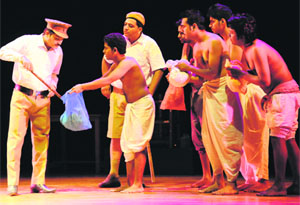 Artistes enact a scene from a play, “Namak Da Daroga”, in Sector 18, Chandigarh, on Friday.