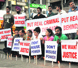 Residents protest against the government and two IPS officials for misusing their powers at Sector 17 in Chandigarh on Friday.