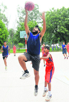 Player of YPS, Mohali, tries to shoot the ball into the basket during a match at the St Johns School, Sector 26, Chandigarh, on Friday.
