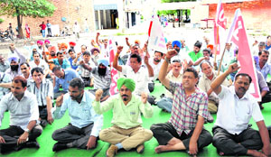 Members of the UT Powermen Union hold a protest at Sector 17 in Chandigarh on Friday.
