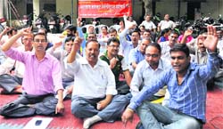 Ministerial workers protest at the Collectorate in Dehradun on Friday. Tribune photo: Abhyudaya Kotnala