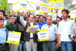 Residents protest against the Mussoorie Dehradun Development Authority and Supreme Court Monitoring Committee in Mussoorie on Friday. a tribune photograph