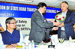 Transport Minister GS Bali being presented a bouquet during a seminar on road safety