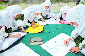 School students take part in a painting competition organised to show their solidarity with the people of Gaza in Srinagar on Friday.