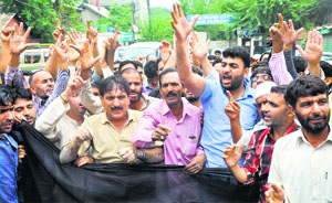 Employees of the PHE Department protest in Srinagar on Friday.