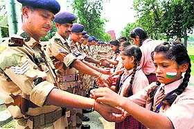 Girl students of St Soldier School tie Rakhi to the personnel of 30th Battalion, ITBP, at Saray Khas in Jalandhar, on Friday. 