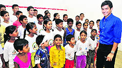 Ace squash champion Saurav Ghosal interacts with children at Khelshala on the occasion of its fifth anniversary at Attawa village in Sector 42, Chandigarh, on Saturday