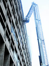 Firemen use hydraulic ladder to enter the eighth floor of the secretariat to douse the fire on Saturday