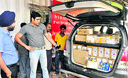 Sales Tax Commissioner Abhishek Duggal (second from left) inspects the impounded Innova car at the tax barrier in Phase VII, Mohali, on Saturday