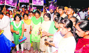 Women take out a candle march to seek Justice for Geetika in Sirsa on Saturday.