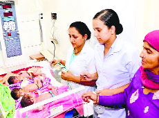 Hospital staff monitors the newborn triplets at the district hospital in Una on Friday.