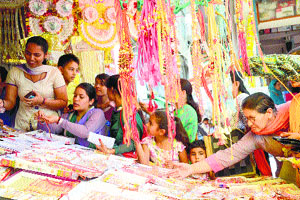 Women buy rakhis on the eve of Raksha Bandhan in Mandi on Saturday.