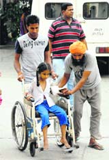 Student of Janta Model School, who sustained injuries in a bus mishap, being taken to Civil Hospital in Jalandhar on Saturday. Photos: Sarabjit Singh