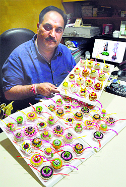 Kapil Kharbanda shows sweets in the shape of rakhi. 