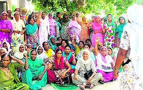 Members of the Mid Day Meal Cooks Front shout slogans against the wrongful detention of their coleagues outside the Kotfatta police station. 