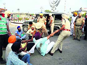 Members of the PRTC Workers Union being dragged by the police in Talwandi Sabo on Sunday. 