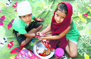 A girl ties a rakhi on her brother during the Rakhi festival in Jalandhar on Sunday. 