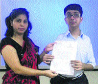 Arav, a student of Eklavya School, shows the letter of commendation for outstanding performance in academics awarded to him