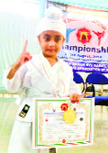 Jasraj Singh shows his certificate and gold medal he won at the National Karate Championship in Diu. 