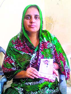  Amarjit Kaur shows her brother Kanwaljit Singhs picture. Both the youths are stuck in Iraq.