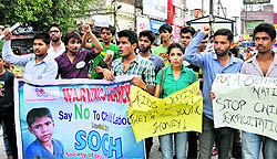 Members of Society for Children Hapiness holds an awareness march against child labour at Clock Tower in Dehradun on Sunday