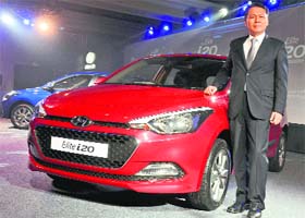 Hyundai Motor India managing director BS Seo poses with Elite i20 at its launch in Delhi on Monday