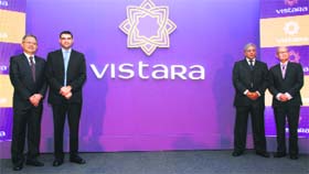 Tata-SIA Airlines officials pose with the logo of the company in New Delhi on Monday