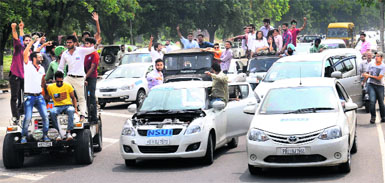 NSUI activists hold a car rally in violation of the pre-poll code on the PU campus on Monday. 