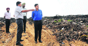 Municipal Commissioner Mohali Uma Shankar Gupta points towards the dumping ground at Industrial Area Phase VIII on Monday.
