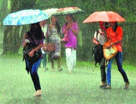 Girls carry umbrellas during heavy rain in Dharamsala on Monday.