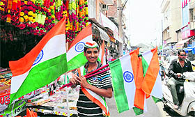 A roadside vendor sells national flag ahead of Independence Day in Jammu on Monday. 