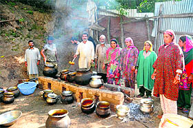  A Kashmiri family prepares the wazwan at Avend village of Shopian district in south Kashmir on Monday.
