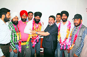 Syed Altaf Bukhari welcomes Jaspal Singh and his supporters into the Peoples Democratic Party in Srinagar on Monday.