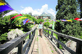 A man crosses a wooden bridge over the Chenab in Lusseni village of the Paddar belt in Kishtwar district.