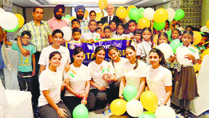 Club members with the underprivilaged children in Ludhiana on Monday.
