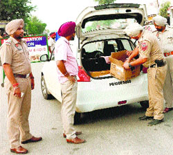 Police personnel search a vehicle in Dehlon near Ahmedgarh on Monday.