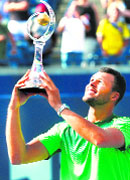 Jo-Wilfried Tsonga holds up the Rogers Cup trophy after his win against Roger Federer in Toronto on Sunday.