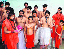 Saint Peethadeeshwar Mahamandaleshwar Kailashanand Maharaj performs a ritual at Neeldhara Chandi ghat in Haridwar on Monday. 