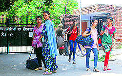 Hostel inmates vacate the hostel, following the notice of suspension of classes till August 18 in Amritsar on Tuesday