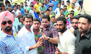Campus president of SOPU Amrit Kaleka (in dark check shirt - centre), along with his supporters, at the Student Centre, Panjab University, on Tuesday.
