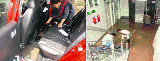 A resident shows water-soaked interiors of a car that was parked outside her residence in Sector 10, Panchkula, on Tuesday; and (right) a waterlogged basement of the General Hospital, Sector 6, Panchkula, on Tuesday.