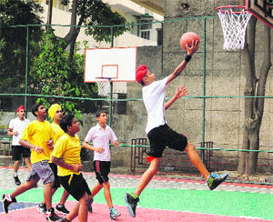 A player shoots the ball into the basket during a match between Shivalik Public School and St Solider School, at Vivek High School, Sector 70, Mohali.
