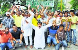 Activists of the Peoples Democratic Party protest outside Government Medical College in Jammu on Tuesday. Tribune photo: Inderjeet Singh