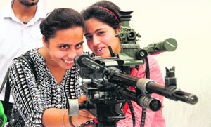 Students of DAV College aim at a target with a gun during an awareness camp organised by the BSF in Jalandhar on Tuesday.