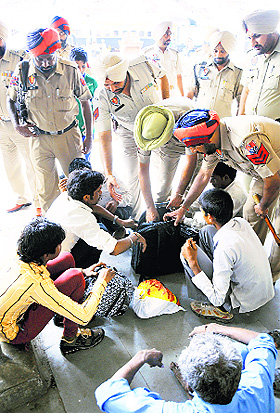 The police check the luggage of passengers at the Ludhiana railway station on Tuesday.
